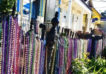 Beads still adorn a fence along Magazine Street a few days after Mardi Gras 2013 in New Orleans.