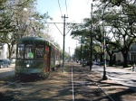 A streetcar heads down St. Charles Avenue. The neutral ground  - the local term for the street median -- is a popular place for runners because of its long unbroken stretch and the soft but sure footing it provides. 