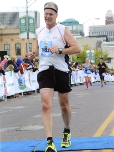 I had a grimace on my face as I crossed the finish line of the Des Moines Marathon in October 2013. I could have run the last two or three miles stronger, but I was happy that I was able to push as hard as I did.