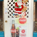 The front door to a restaurant in Santa Cruz, Belize, is decorated for both Christmas and the happy times of rum and Coke. Santa Cruz is about 20 miles north of Placencia, Belize.